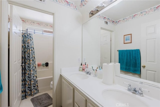 full bath featuring double vanity, shower / bath combo, toilet, and a sink