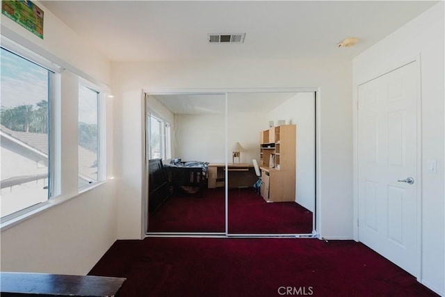 hallway featuring visible vents and carpet flooring