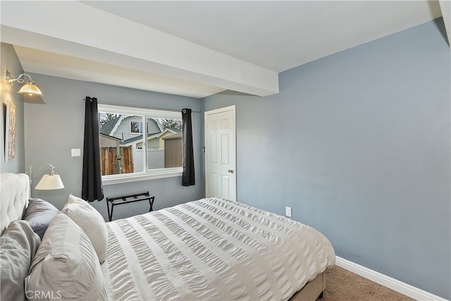 carpeted bedroom featuring baseboards