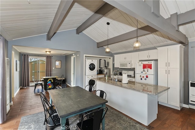 dining area featuring vaulted ceiling with beams, stacked washer and dryer, baseboards, and dark wood-style floors