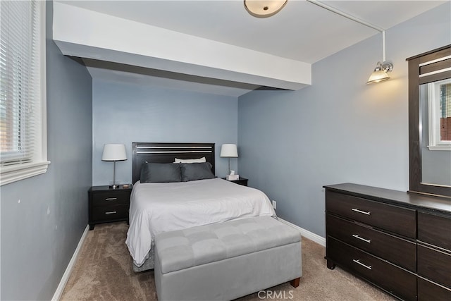 bedroom with carpet floors and baseboards