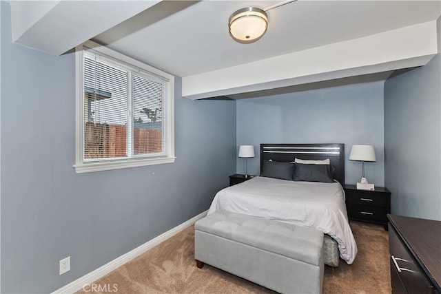 carpeted bedroom featuring baseboards