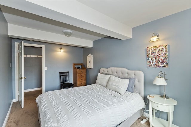 bedroom with carpet floors, beam ceiling, and baseboards