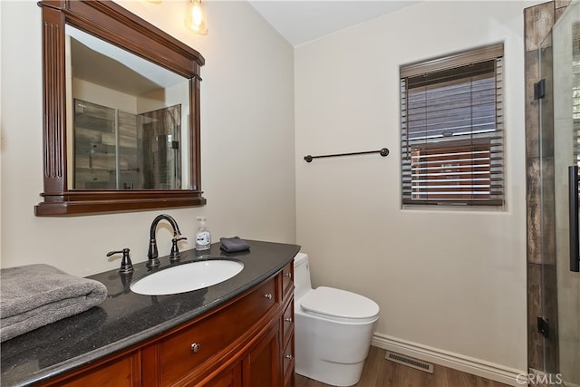 bathroom featuring toilet, wood finished floors, vanity, visible vents, and a stall shower