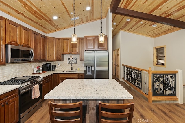 kitchen with tasteful backsplash, lofted ceiling with beams, appliances with stainless steel finishes, a sink, and wooden ceiling