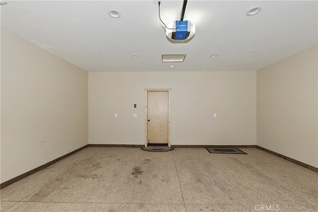 garage featuring a garage door opener, recessed lighting, and baseboards