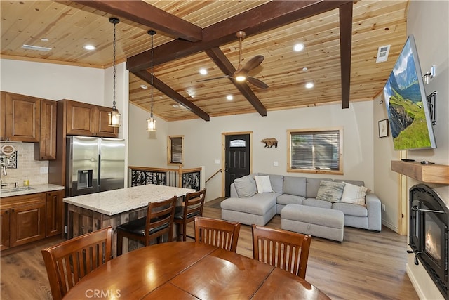 dining area featuring dark wood-style flooring, wooden ceiling, and visible vents