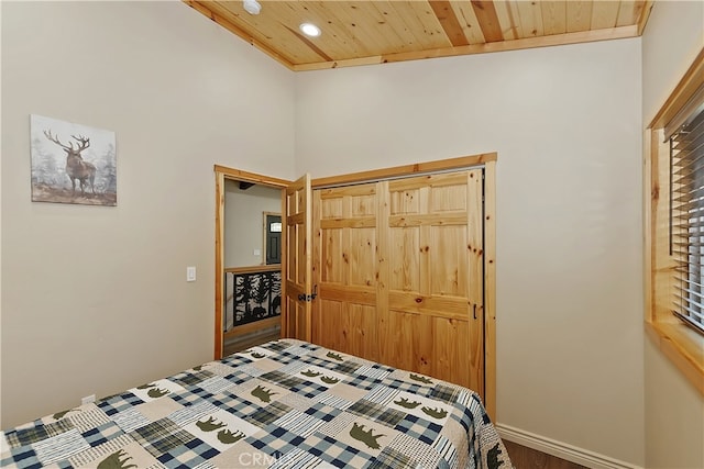 bedroom with recessed lighting, a closet, wooden ceiling, and baseboards