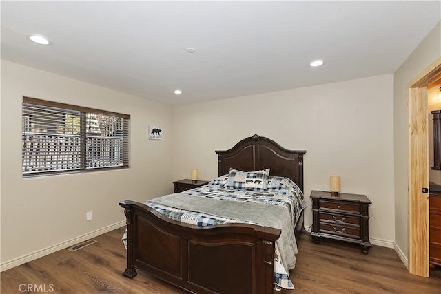 bedroom featuring baseboards, visible vents, and dark wood-type flooring