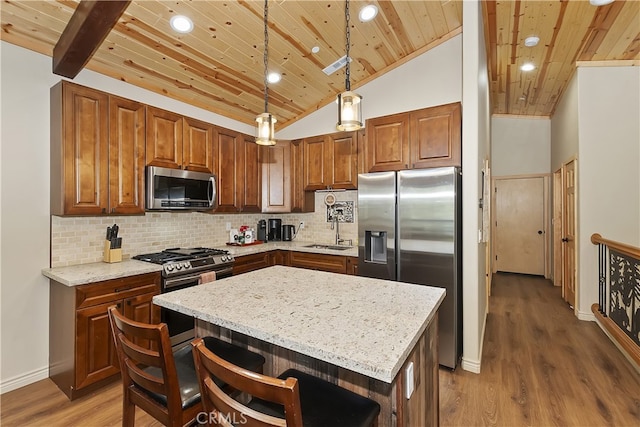 kitchen with tasteful backsplash, wood ceiling, appliances with stainless steel finishes, light stone counters, and a sink