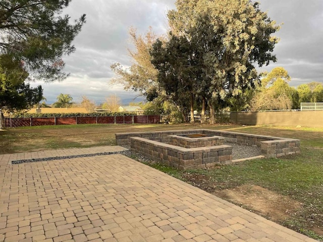 surrounding community with a patio area, fence, and a lawn