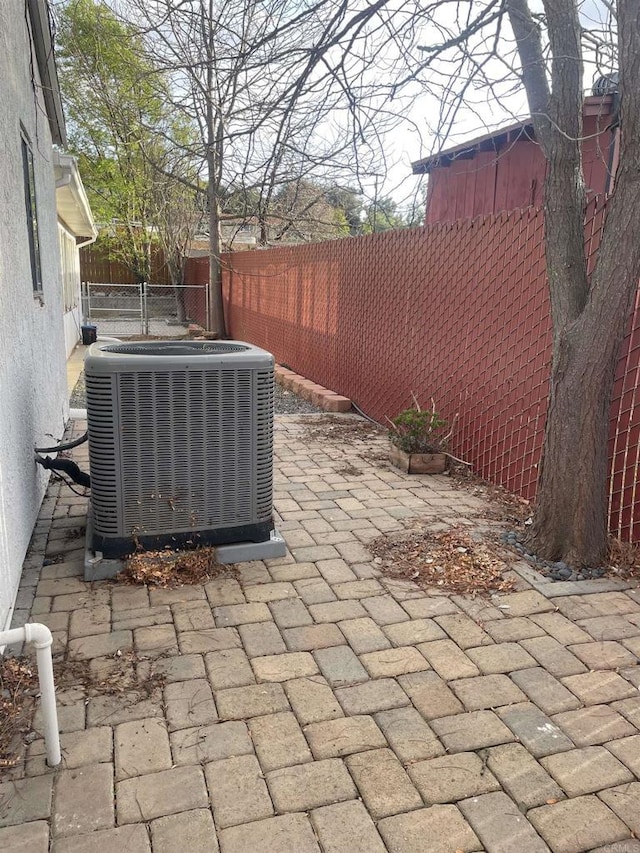 view of patio / terrace with cooling unit and a fenced backyard