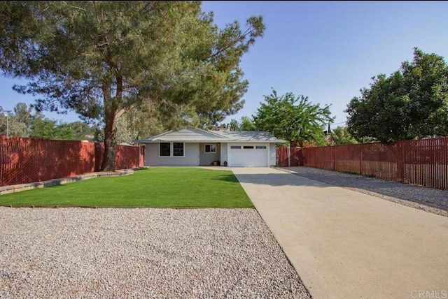 single story home featuring an attached garage, driveway, a front lawn, and fence