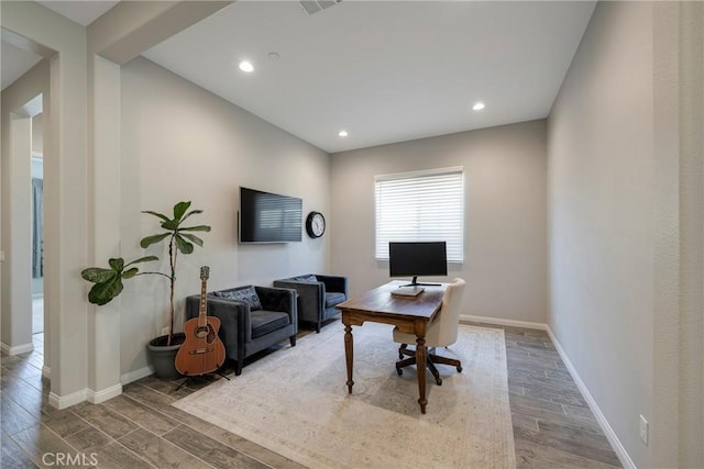 office space with recessed lighting, wood finished floors, and baseboards