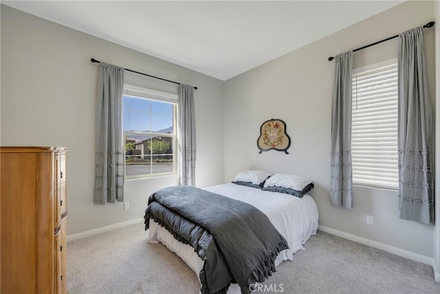 carpeted bedroom with baseboards