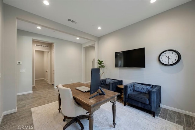 office featuring recessed lighting, visible vents, baseboards, and wood finished floors