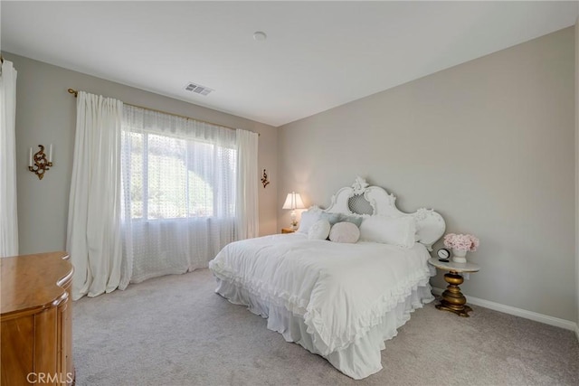 bedroom with carpet, visible vents, and baseboards