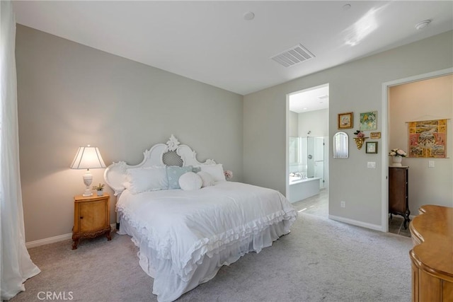 bedroom featuring visible vents, light carpet, baseboards, and ensuite bathroom