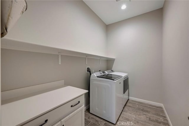 washroom with wood tiled floor, baseboards, separate washer and dryer, and recessed lighting