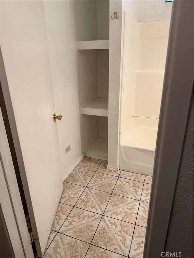 full bathroom featuring a bathtub and tile patterned floors