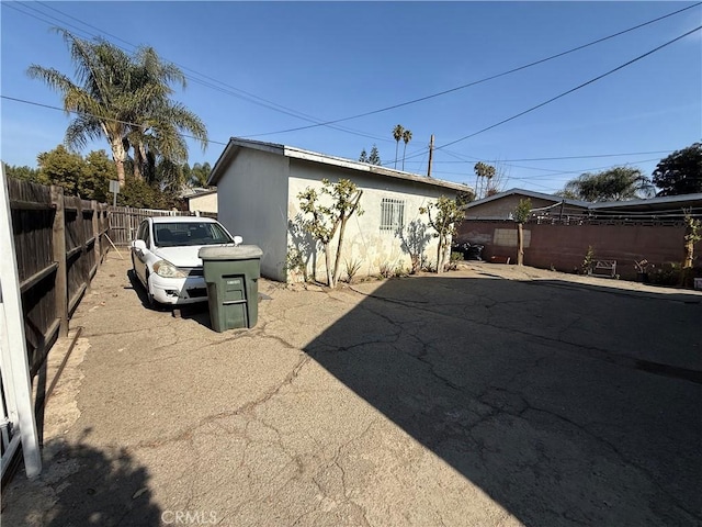 view of property exterior with a fenced backyard and stucco siding