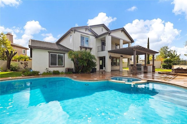 rear view of house featuring a balcony, a patio area, fence, and a pergola