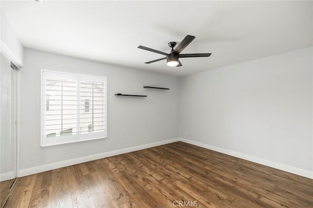 unfurnished room with ceiling fan, baseboards, and wood finished floors