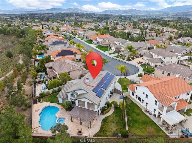 drone / aerial view featuring a residential view and a mountain view