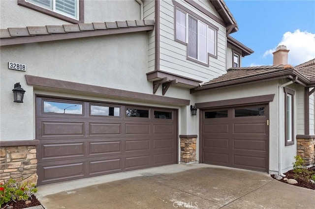 garage featuring concrete driveway