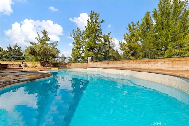 view of swimming pool with fence and a fenced in pool