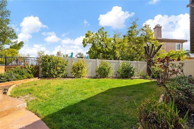 view of yard with a fenced backyard