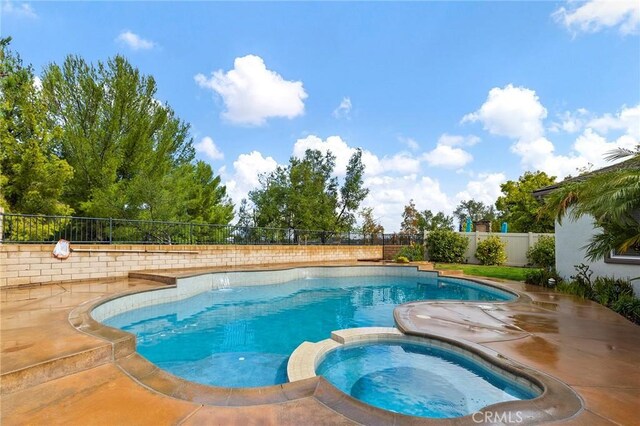 view of pool with a patio area, a fenced backyard, and a pool with connected hot tub