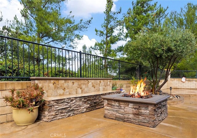 view of patio with an outdoor fire pit and a fenced backyard