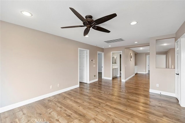 unfurnished room with recessed lighting, visible vents, light wood-style flooring, a ceiling fan, and baseboards