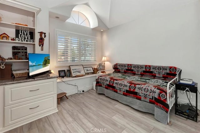 bedroom featuring vaulted ceiling and light wood-style floors