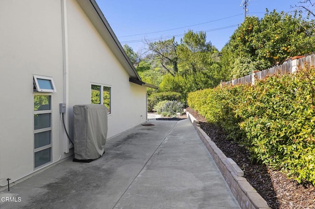 1037 Westridge Dr, Ventura, CA 93003 - view of side of home with stucco siding, a patio, and fence