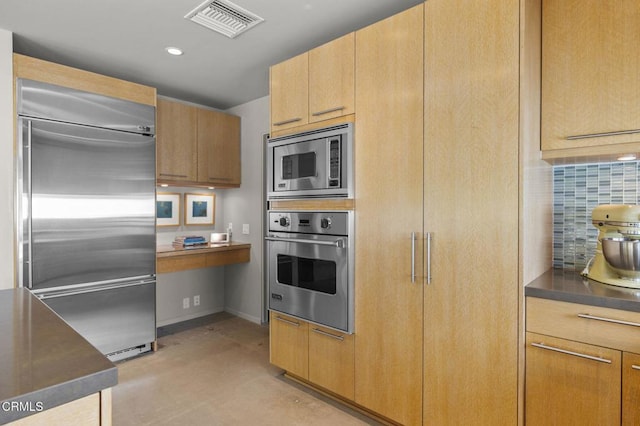 1037 Westridge Dr, Ventura, CA 93003 - kitchen with dark countertops, concrete flooring, built in appliances, backsplash, and visible vents