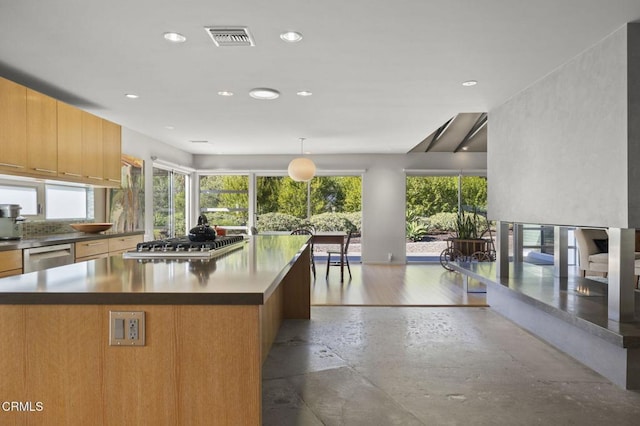 1037 Westridge Dr, Ventura, CA 93003 - kitchen with stainless steel appliances, a center island, visible vents, recessed lighting, and backsplash