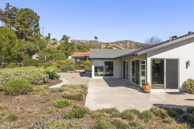 1037 Westridge Dr, Ventura, CA 93003 - rear view of house with stucco siding, a mountain view, and a patio