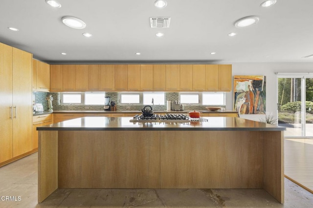 1037 Westridge Dr, Ventura, CA 93003 - kitchen with dark countertops, visible vents, a large island, and backsplash