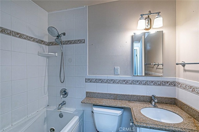 full bathroom with toilet,  shower combination, vanity, and tile walls