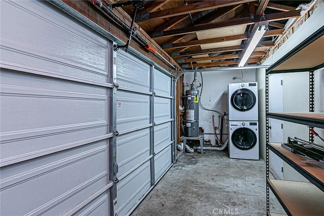 garage with stacked washer and dryer and water heater