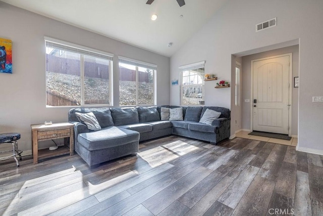 living room featuring baseboards, visible vents, a ceiling fan, wood finished floors, and high vaulted ceiling