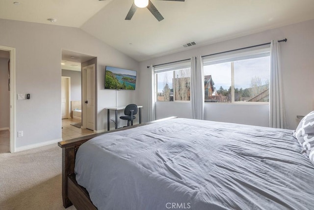 bedroom featuring lofted ceiling, carpet floors, visible vents, baseboards, and a ceiling fan