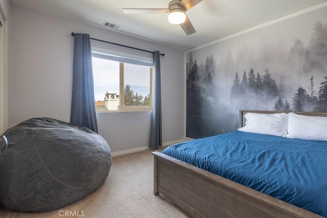 carpeted bedroom featuring a ceiling fan, visible vents, and baseboards