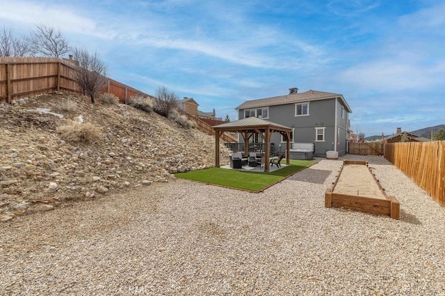 back of house featuring a patio area, a fenced backyard, and a gazebo