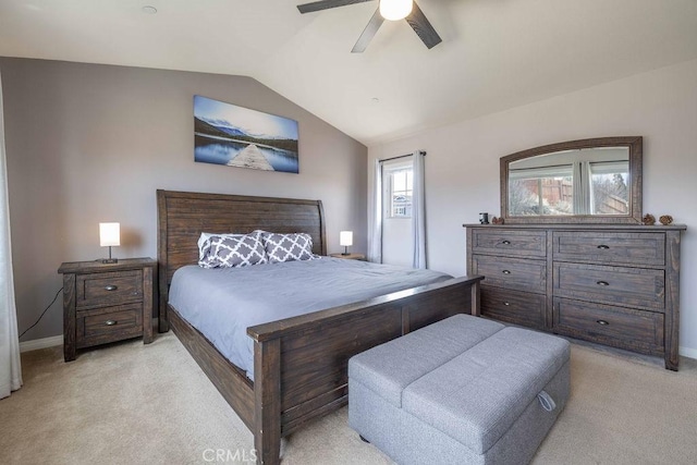 bedroom featuring lofted ceiling, baseboards, a ceiling fan, and light colored carpet