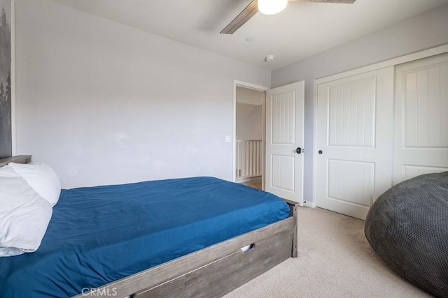 carpeted bedroom with a closet and a ceiling fan