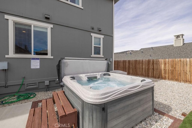 exterior space featuring a hot tub and fence