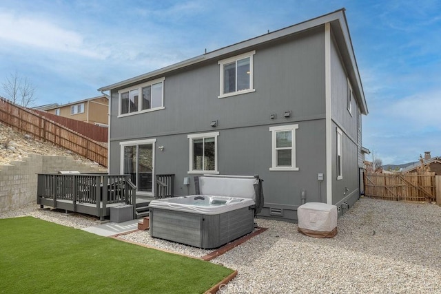 back of property featuring a deck, a fenced backyard, cooling unit, crawl space, and a hot tub